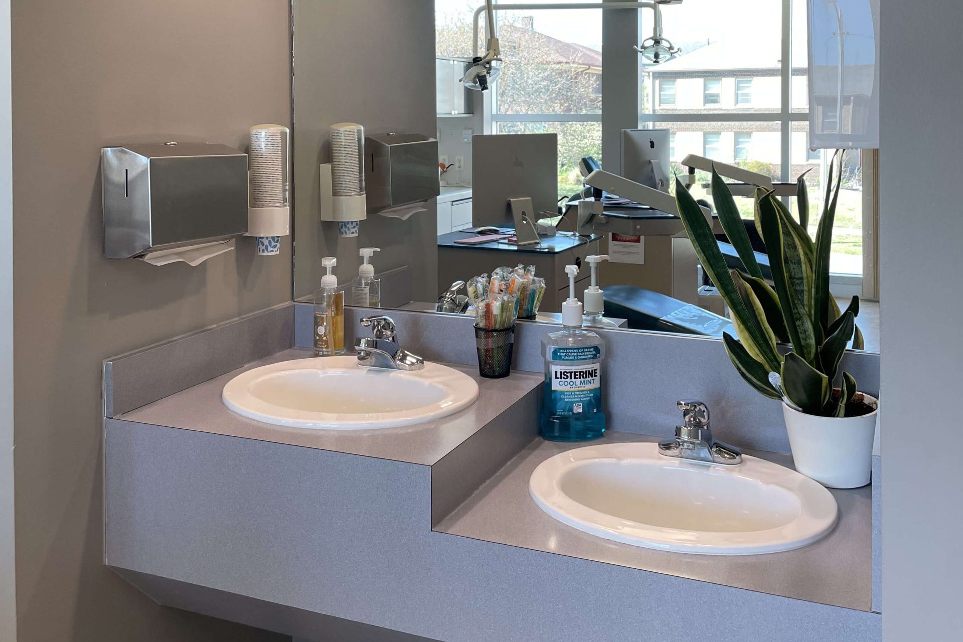 brushing station with sinks and a mirror