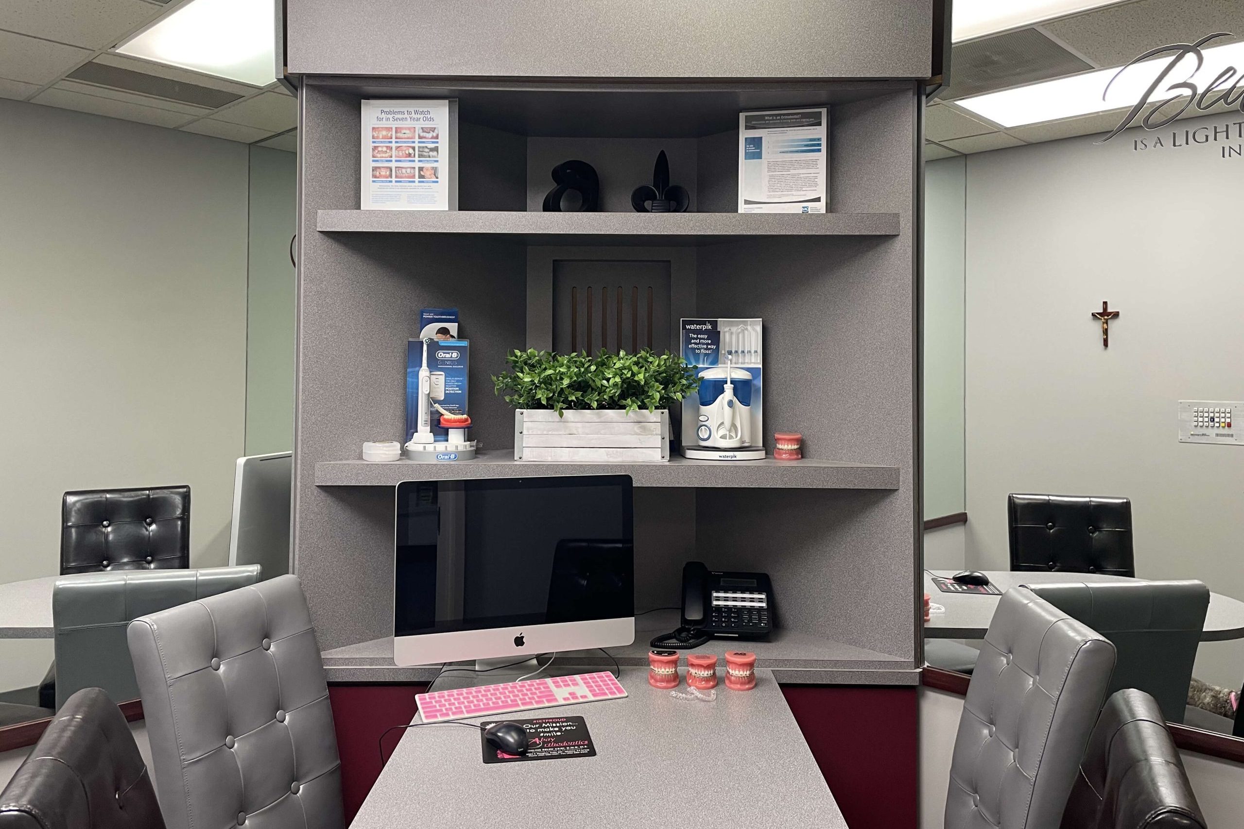 office with 4 office chairs, a desk, computer, and mirror walls
